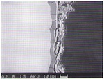 Fig. 7. Section through the surface of the model glass after
                            weathering in the climate chamber (electron microscope).