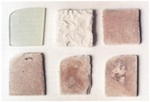 Fig. 8. Samples of a model glass: (top left) untreated state; (top
                            centre) after 10 weeks of weathering; (top right and below) as top
                            centre, but after removal of the corrosion crusts.